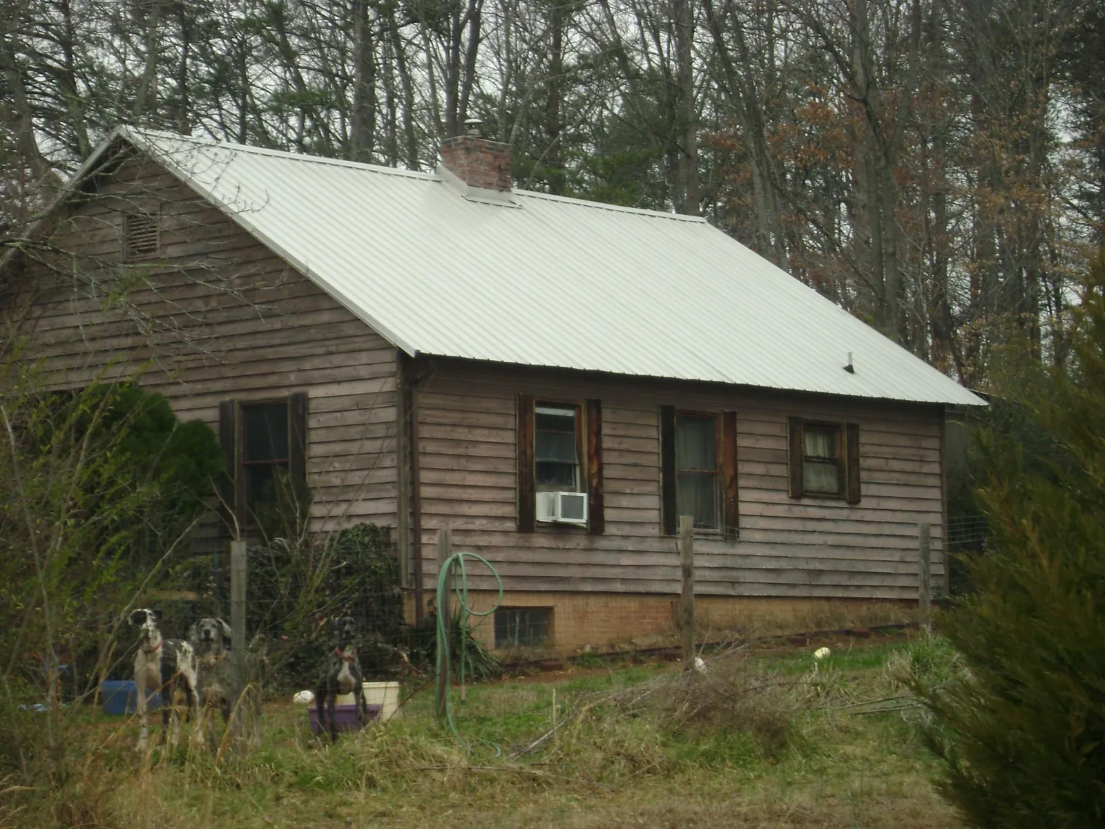 White metal roof on an old wood sided farmhouse, from a Metal Roof Installation job in Wynne